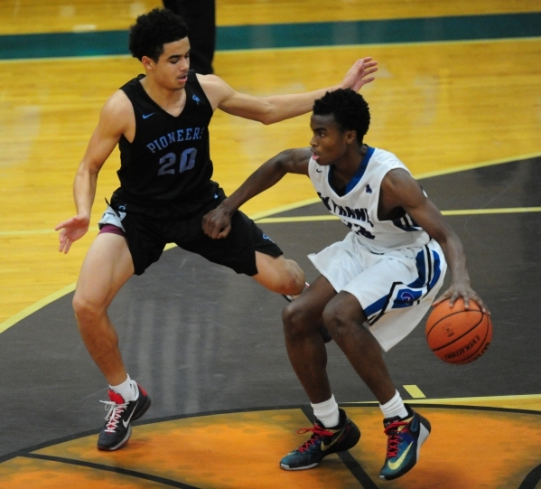 Canyon Springs forward Joseph Haulcy (20) defends Silverado guard Errol Newman (23) in the b ...