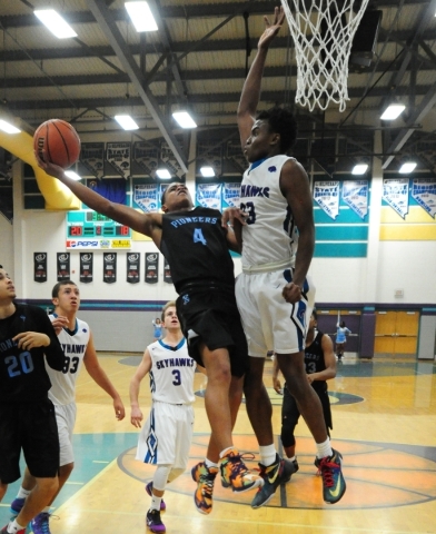 Silverado guard Errol Newman (23) fouls Canyon Springs guard Derrick Legardy (4) in the seco ...