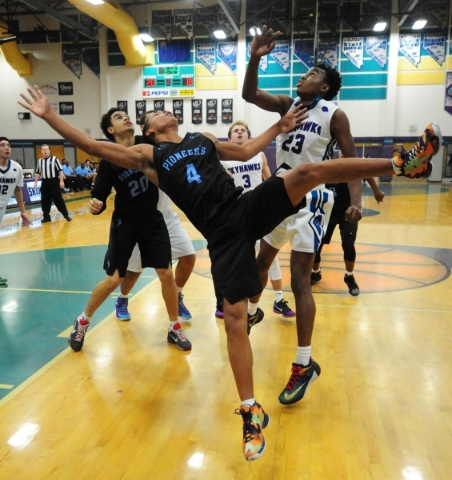 Canyon Springs guard Derrick Legardy (4) falls to the floor after being fouled by Silverado ...