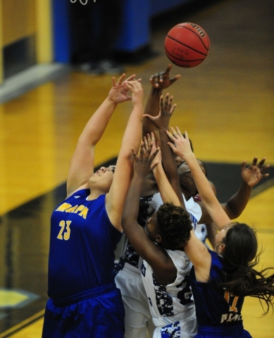 Moapa Valley center Kaila Enosa (23) fights Desert Pines guard Jordan Bailey for a rebound i ...