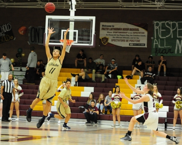 Spring Valley guard Kayla Harris (11) intercepts a pass intended for Faith Lutheran guard Bo ...