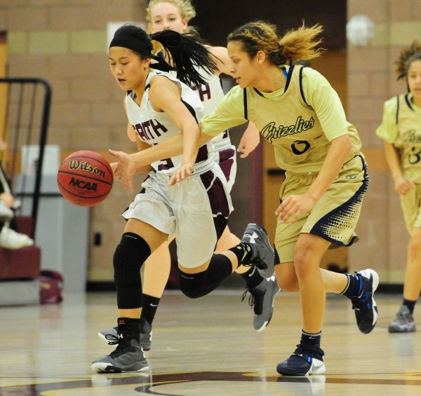 Spring Valley guard Essence Booker, right, knocks the ball away from Faith Lutheran guard Ma ...