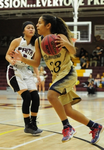 Spring Valley forward Nohely Moreno (33) drives past Faith Lutheran guard Maddie Bocobo in t ...