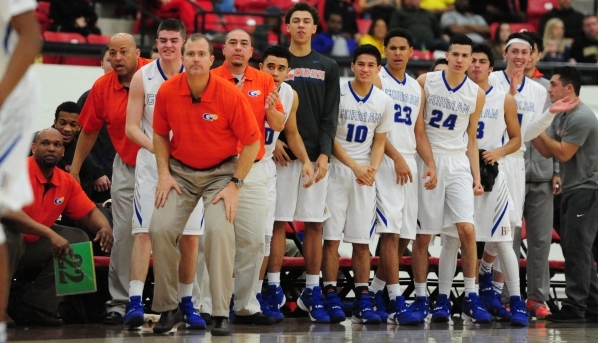 Bishop Gorman head coach Grant Rice, middle left, and players look on in the closing minutes ...
