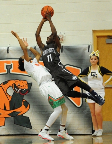 Cheyenne guard Laron Perkins (11) is upended after fouling Mojave guard Richard Edwards in t ...