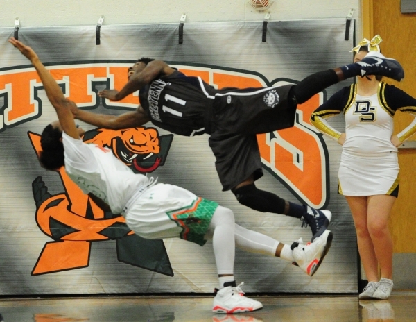 Cheyenne guard Laron Perkins (11) is upended after fouling Mojave guard Richard Edwards in t ...