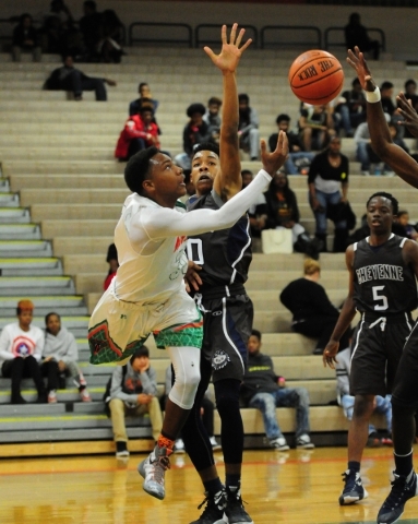 Mojave guard J.D. McCormick goes up for a shot in front of Cheyenne forward William Federson ...