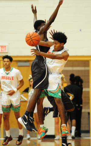 Mojave guard Lamaja Cunningham passes while Cheyenne guard Alahjan Banks defends in the firs ...