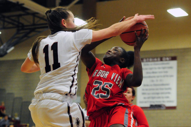 Desert Oasis guard Ashlynn Sharp (11) fouls Arbor View guard Alaysia Reed (25) in the third ...