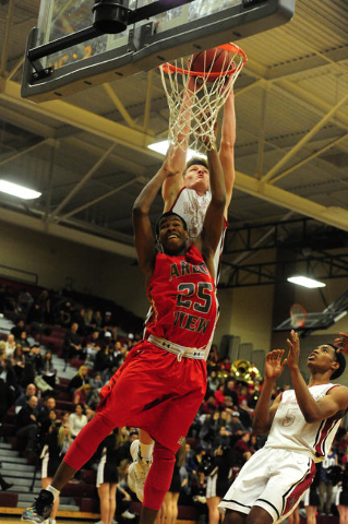 Desert Oasis forward Jacob Heese dunks over Arbor View guard Jarrod Burks in the second quar ...