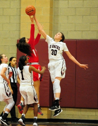 Desert Oasis center Sierra Mich‘l (30) blocks the shot attempt of Arbor View guard Car ...