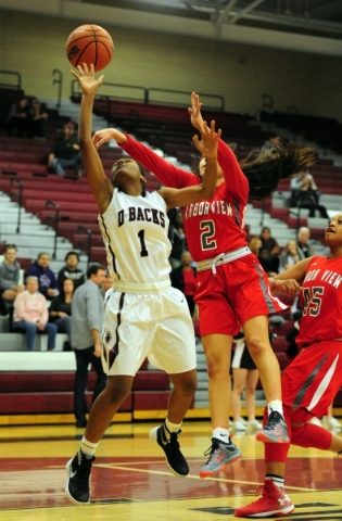 Arbor View guard Caroline Rivera-Cervantes (2) fouls Desert Oasis guard Taryn Lampkin (1) i ...