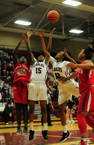 Desert Oasis guards Ahmaya Smith (15), KePatriot Simpson (12) Arbor View guard Alaysia Reed ...