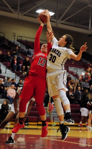 Desert Oasis center Sierra Mich‘l (30) blocks the shot attempt of Arbor View guard Kat ...