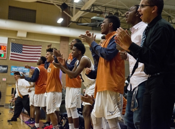 Members of the Legacy High School boys basketball team celebrate from the bench during their ...