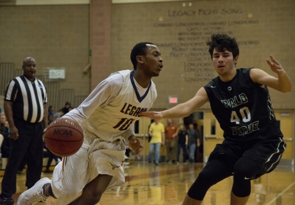 LegacyÃ«s Edward Vaughns (10) works the ball toward the basket as Palo Verde‘s Doru ...