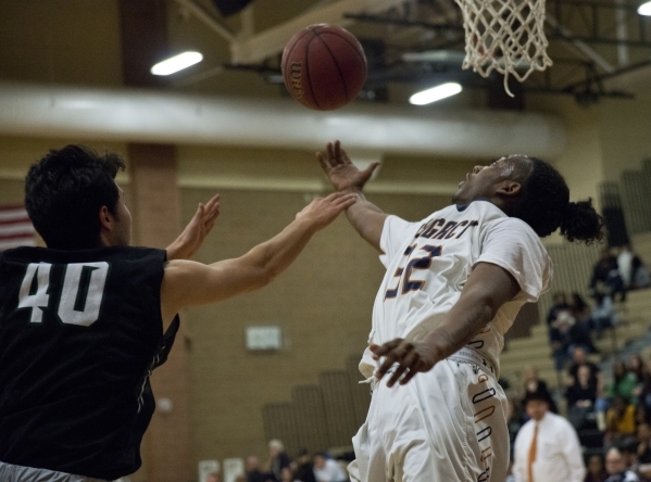 LegacyÃ«s Kameron Delgadillo attempts a shot at the basket as Palo Verde‘s Doru Simi ...