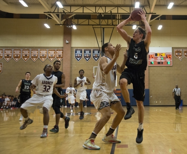 Palo VerdeÃ«s James Camp (5) shoots as Legacy‘s Darious Dunson (11) defends during t ...