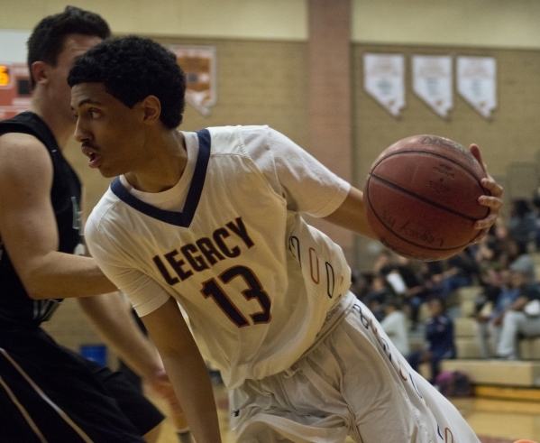 Legacy‘s Aidan Subira (13) works the ball toward the basket during their home game aga ...