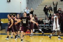 Faith Lutheran players celebrate their 97-89 quadruple overtime win over Cheyenne during the ...