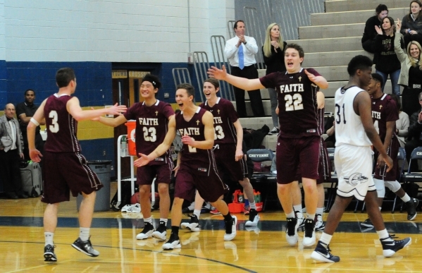 Faith Lutheran players celebrate their 97-89 quadruple overtime win over Cheyenne during the ...