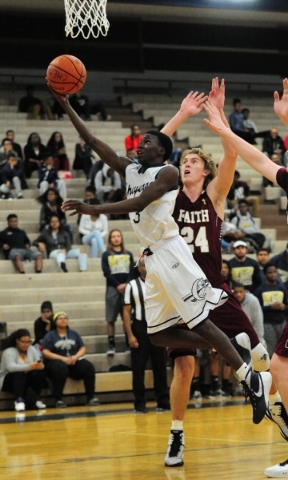 Cheyenne guard Alahjan Banks (3) goes up for a shot against Faith Lutheran forward Bryce Nea ...