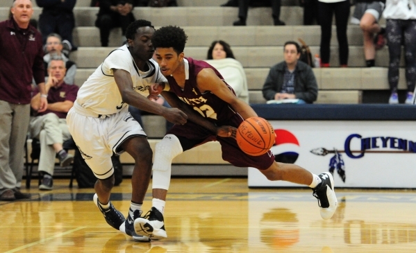 Faith Lutheran guard Jaylen Fox, right, dribbles the ball up-court while Cheyenne guard Alah ...