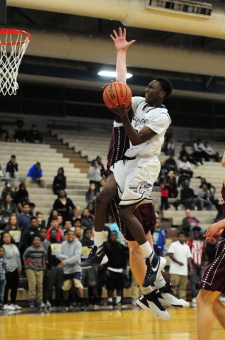 Cheyenne wing Dewayne Alexander goes up for a shot against Faith Lutheran forward Zach Friel ...