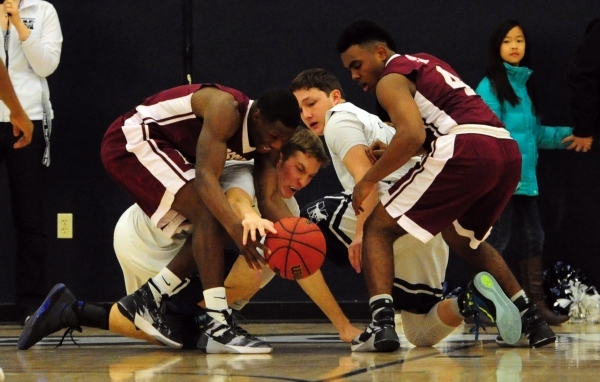 Agassi Prep guard Stephan Laushaul, left, forward Daniel Plummer (4), The Meadows guard Jake ...