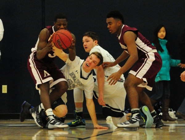 Agassi Prep guard Stephan Laushaul, left, forward Daniel Plummer (4), The Meadows guard Jake ...