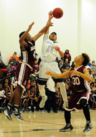 Agassi Prep forward Daniel Plummer (4) blocks the shot attempt of The Meadows guard Asheesh ...