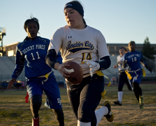 Boulder City quarterback Jeanne Carmell (14) runs the ball up the field during their game ag ...