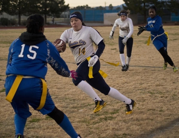 Boulder City quarterback Jeanne Carmell (14) runs the ball up the field during their game ag ...