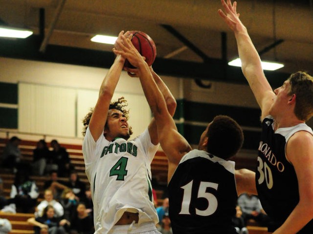 Green Valley guard Xavier Jarvis (4) goes up for a shot against Coronado forward Kennedy Koe ...