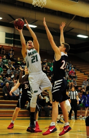 Green Valley forward Canyon Lewis (21) goes up for a shot against Coronado forward Jake Desj ...