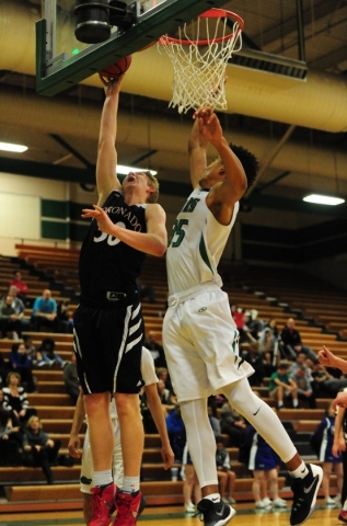 Coronado forward Kennedy Koehler (30) goes up for a shot against Green Valley forward Isiah ...