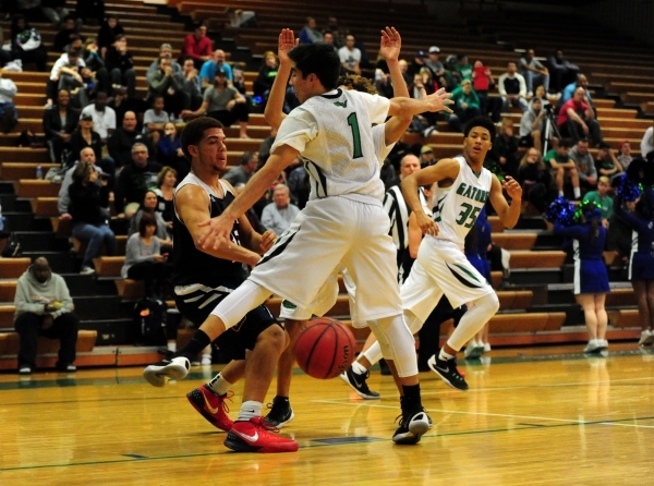 Coronado guard Bryce Savoy passes through the legs of Green Valley guard Ryan Trejo (1) in t ...