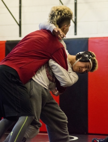 Antonio Saldate, right, spars with Nick Sablan during practice inside the wrestling room at ...