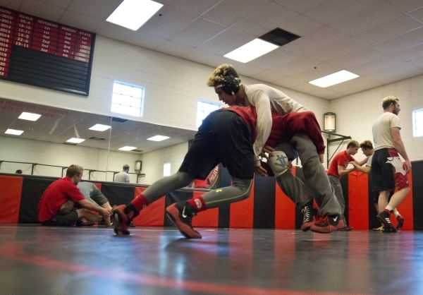 Antonio Saldate, top, spars with Nick Sablan during practice inside the wrestling room at La ...