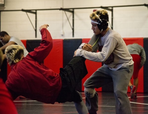 Antonio Saldate, right, spars with Nick Sablan during practice inside the wrestling room at ...