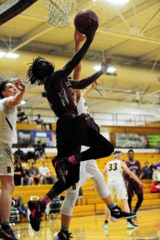 Cimarron-Memorial guard Demarco Alexander (23) goes up for a shot against Bonanza guard Jama ...