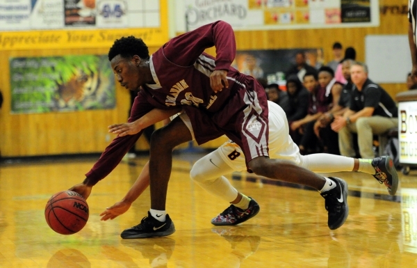 Cimarron-Memorial guard Ja‘Don Brown (20) fights for a loose ball against Bonanza guar ...