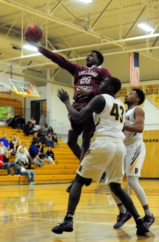 Cimarron-Memorial guard Ja‘Don Brown (20) goes up for a shot against Bonanza center Ga ...