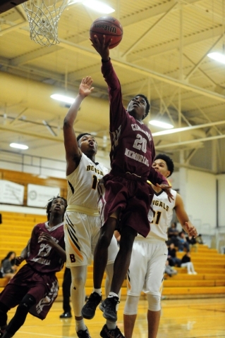 Cimarron-Memorial guard Ja‘Don Brown (20) goes up for a shot against Bonanza guard Jam ...