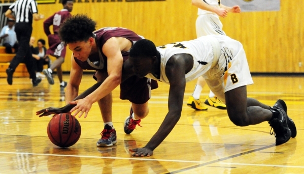 Bonanza center Garnet Walters, right, and Cimarron-Memorial guard Quentin Matthews dive for ...