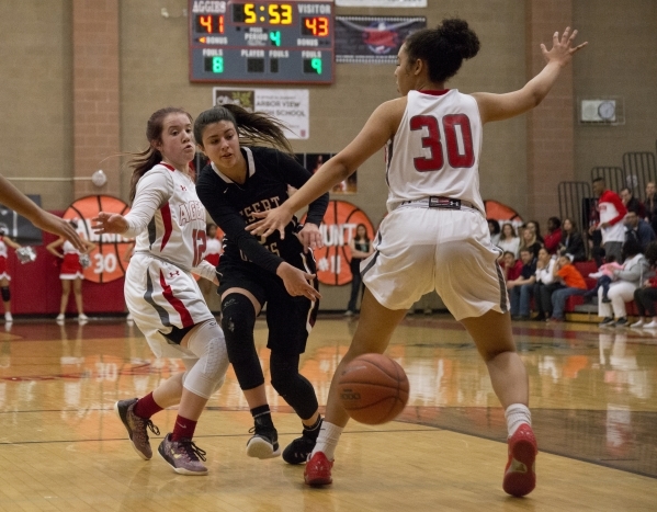 Desert Oasis guard Mikala Kirby (3) passes the ball around Arbor View‘s Jordan Dawkins ...