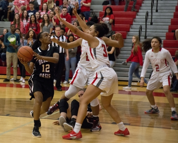 Desert Oasis guard KePatriot Simpson (12) works the ball toward the basket during their game ...