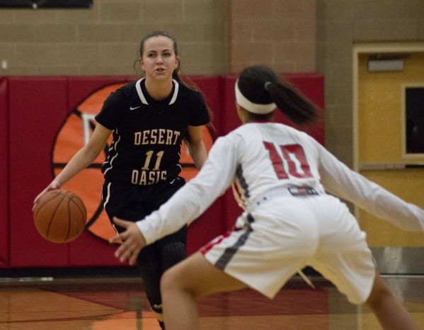 Desert Oasis guard Ashlynn Sharp (11) dribbles the ball against Arbor View‘s Tiffani S ...