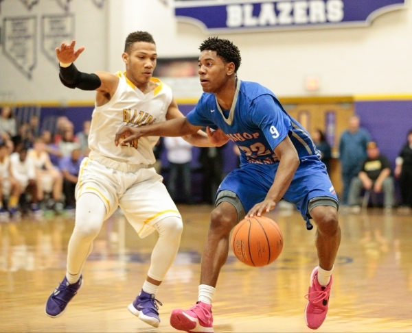 Bishop Gorman junior Christian Popoola (22) guard makes a move with the ball, while Durango ...