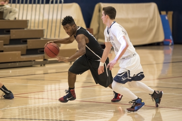 Mountain View Saints guard Tevin Gray (11) goes around Meadows Mustangs guard Jake Epstein ( ...